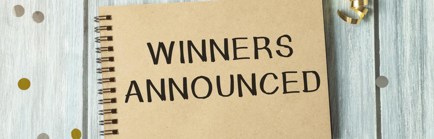 winners announced written on notebook