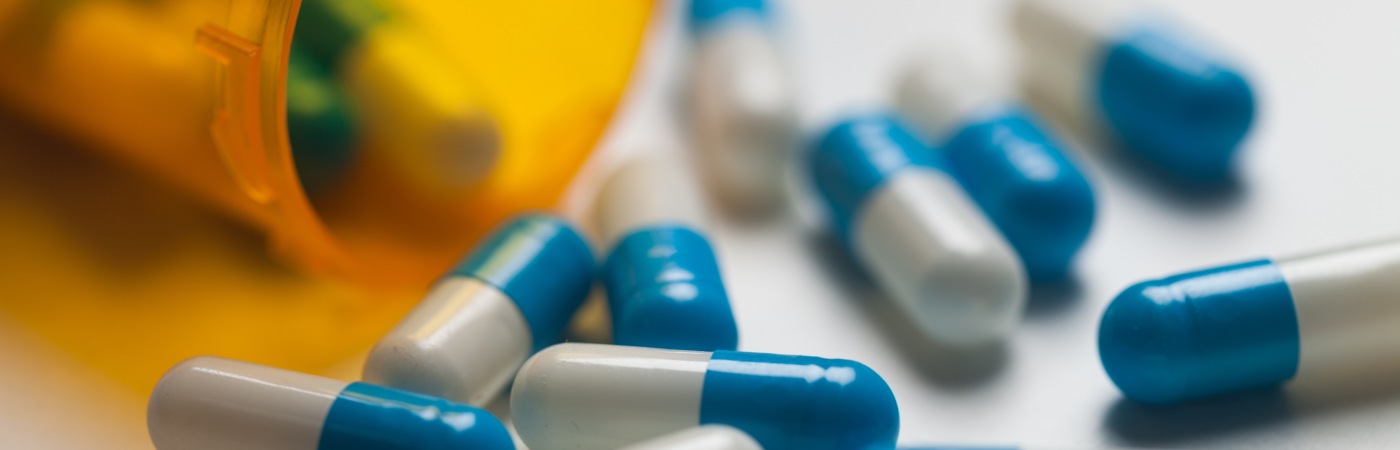 Pills spill out of a bottle