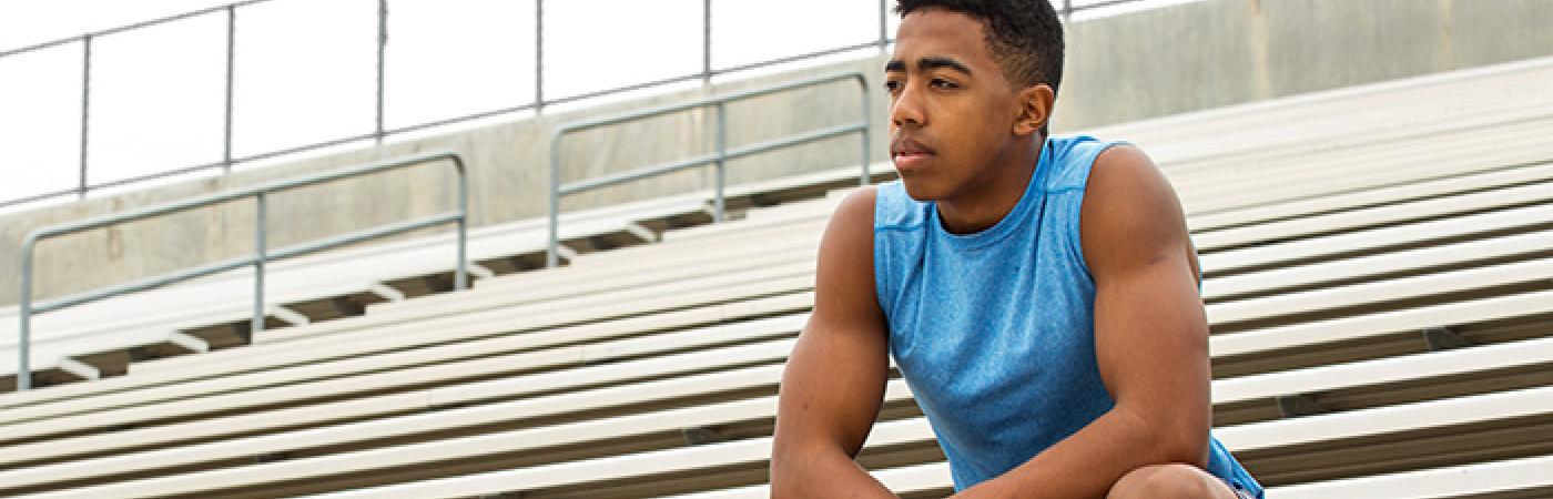 teen sitting in bleachers