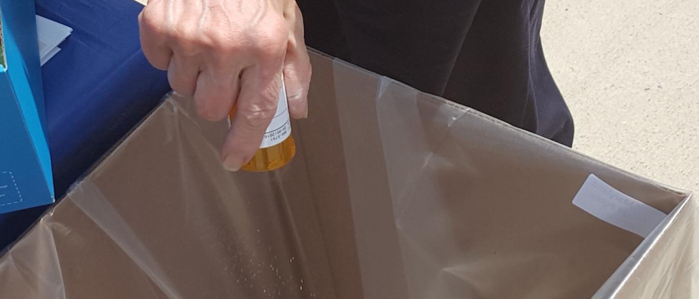 man disposing of pills during Take Back Day
