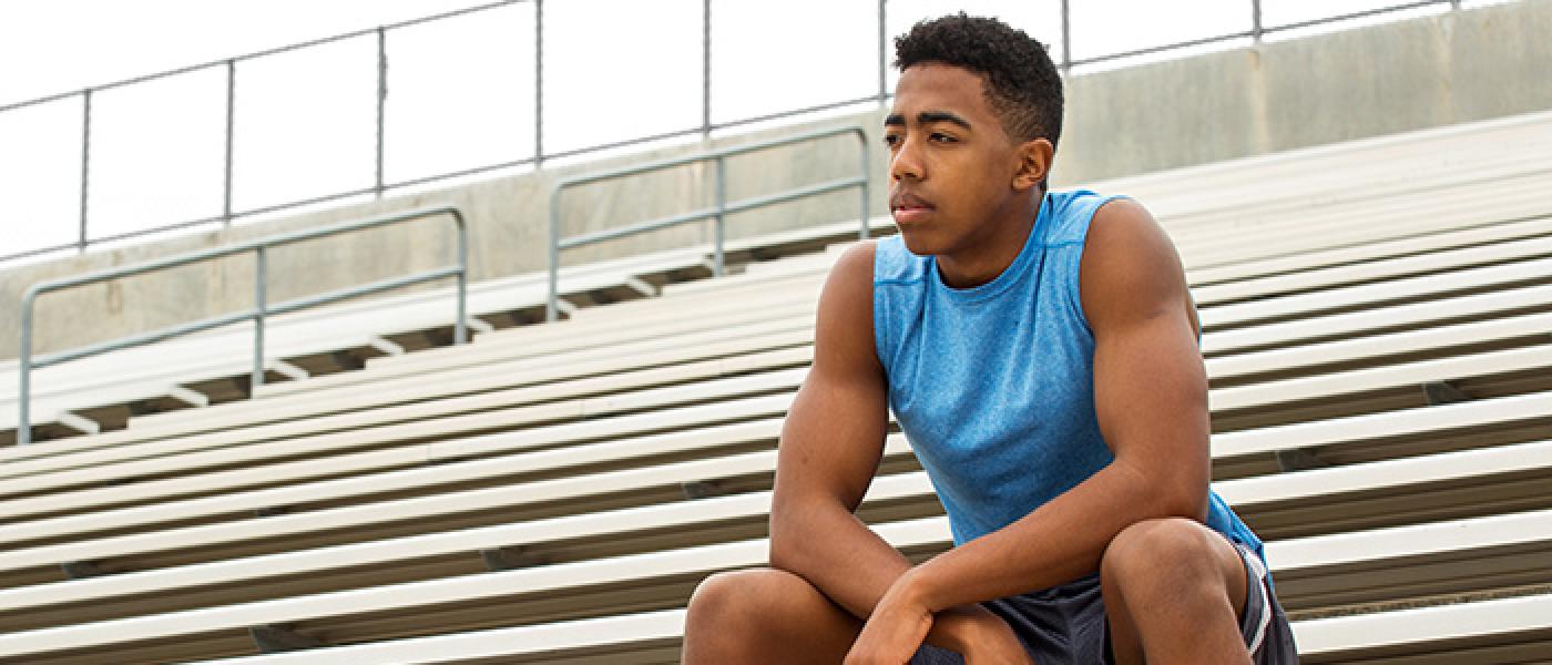 teen sitting in bleachers