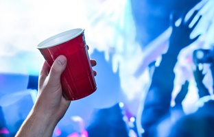 a person holding a red cup at a party